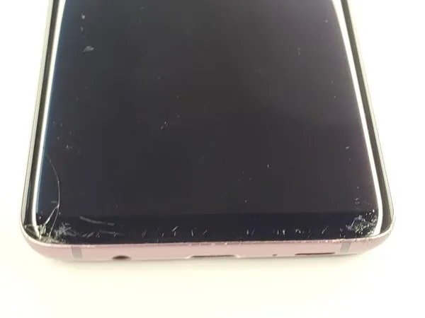 Samsung Galaxy S9+ screen crack and bottom edge chipping close-up